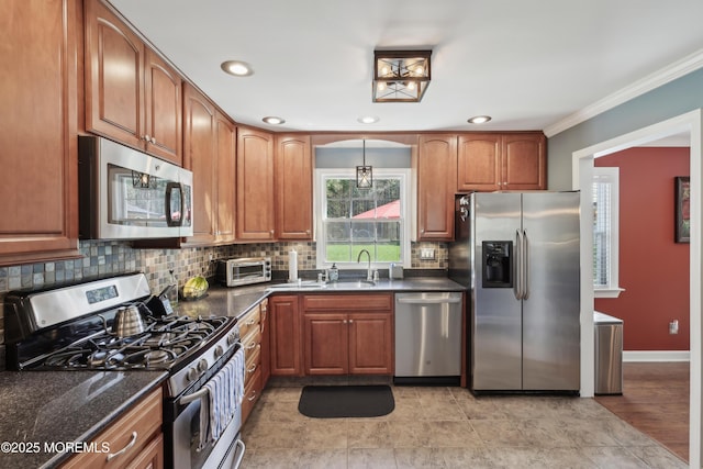 kitchen featuring brown cabinetry, ornamental molding, appliances with stainless steel finishes, and backsplash