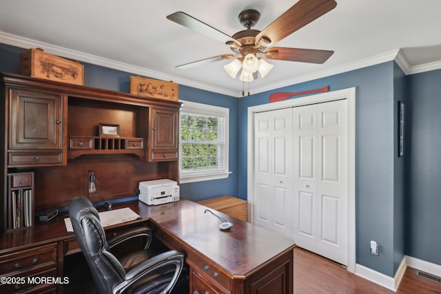office area featuring ceiling fan, visible vents, ornamental molding, and wood finished floors