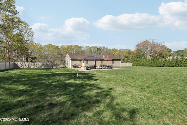 view of yard featuring a patio, a gazebo, and a fenced backyard