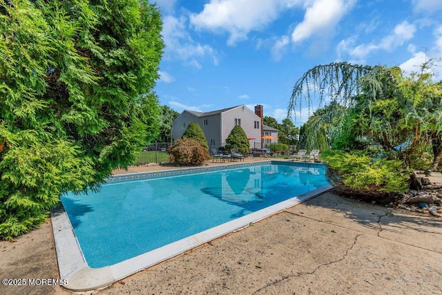 1 Flintlock Rd, Freehold, NJ 07728 - view of swimming pool with a fenced in pool, a patio area, and fence