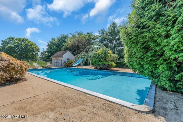 1 Flintlock Rd, Freehold, NJ 07728 - view of swimming pool featuring an outbuilding, fence, a fenced in pool, a patio, and a water slide