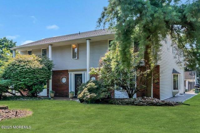 1 Flintlock Rd, Freehold, NJ 07728 - view of front facade featuring brick siding and a front yard