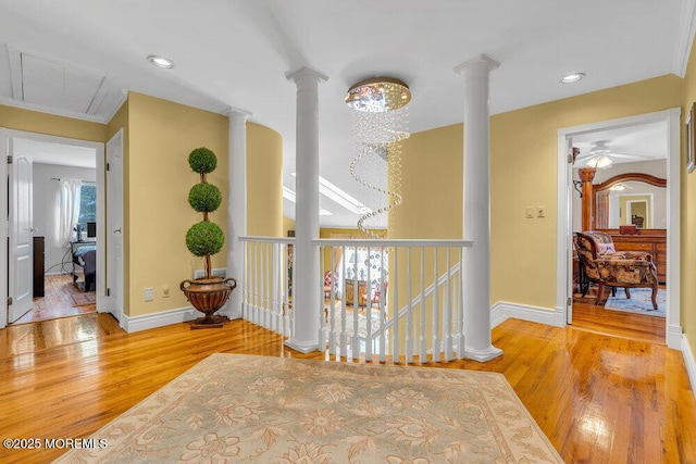 1 Flintlock Rd, Freehold, NJ 07728 - hall featuring ornate columns, baseboards, an upstairs landing, and wood finished floors