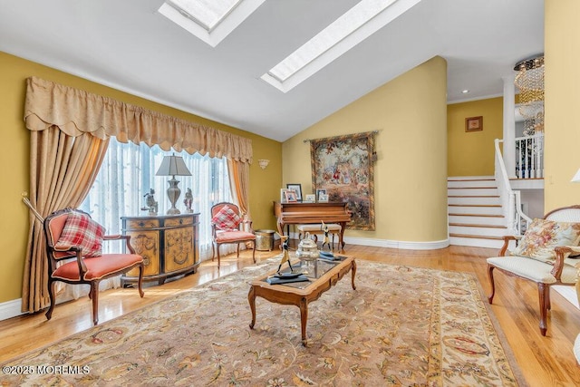 1 Flintlock Rd, Freehold, NJ 07728 - sitting room featuring baseboards, wood finished floors, vaulted ceiling with skylight, and stairway