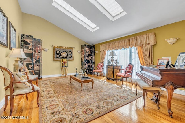 1 Flintlock Rd, Freehold, NJ 07728 - living room with baseboards, lofted ceiling with skylight, and wood finished floors
