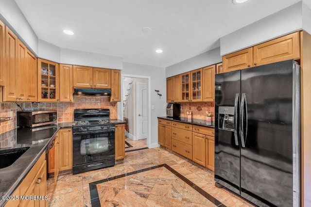 1 Flintlock Rd, Freehold, NJ 07728 - kitchen with under cabinet range hood, dark countertops, black appliances, and tasteful backsplash