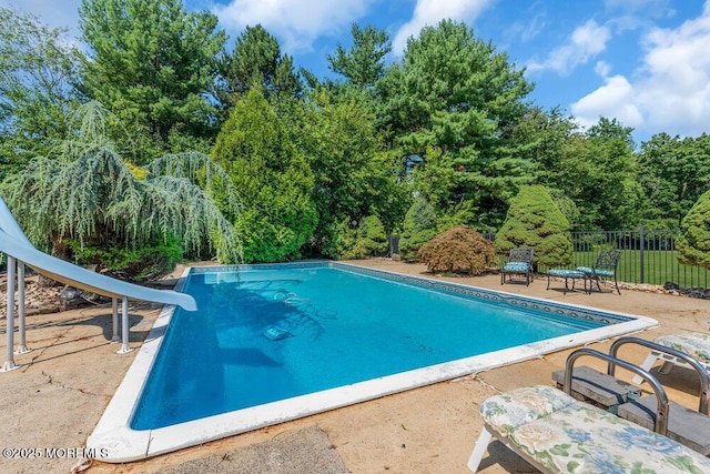 1 Flintlock Rd, Freehold, NJ 07728 - view of swimming pool with a fenced in pool, fence, a water slide, and a patio area