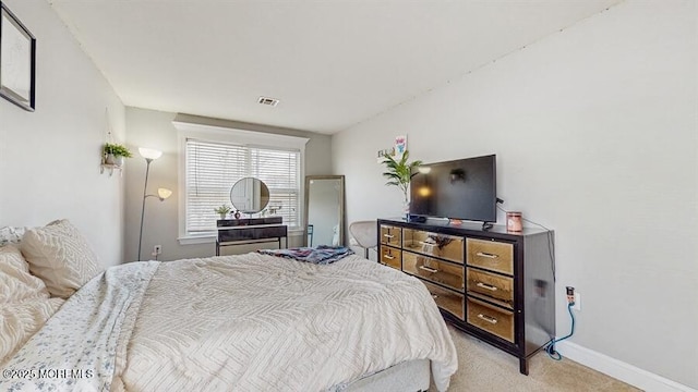carpeted bedroom with baseboards and visible vents