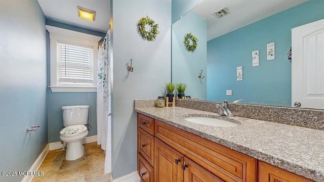 bathroom with vanity, tile patterned flooring, visible vents, toilet, and baseboards