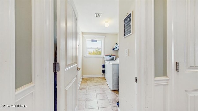 laundry area with laundry area, light tile patterned flooring, visible vents, and washing machine and clothes dryer