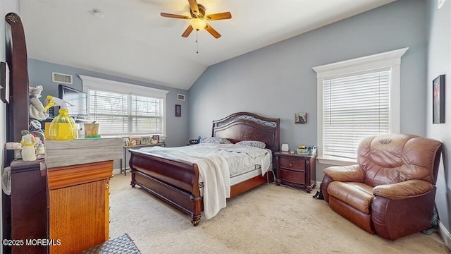 bedroom featuring a ceiling fan, light colored carpet, lofted ceiling, and visible vents