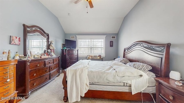 bedroom with a ceiling fan, multiple windows, light carpet, and vaulted ceiling