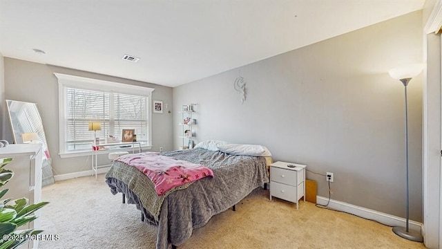 bedroom featuring baseboards, light colored carpet, and visible vents