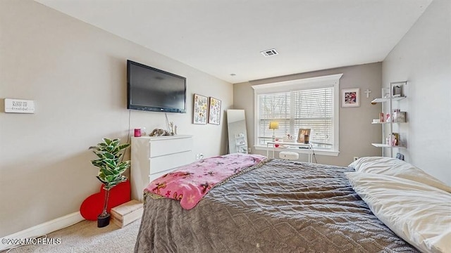 bedroom with carpet flooring, baseboards, and visible vents