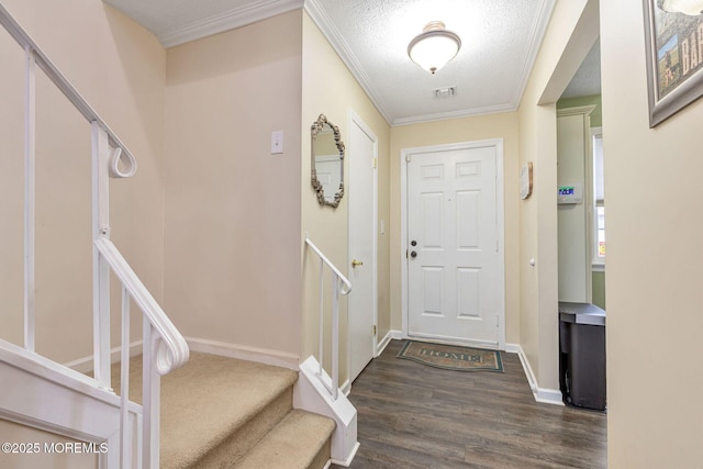 doorway to outside with dark wood-style flooring, a textured ceiling, stairs, baseboards, and ornamental molding