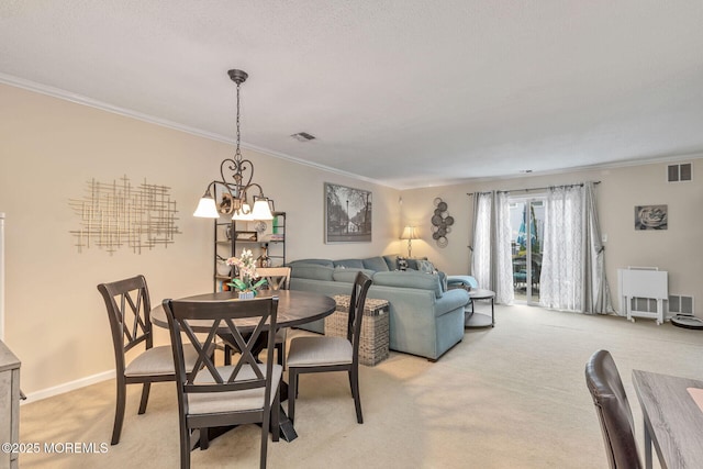 dining area with crown molding, light carpet, a notable chandelier, and visible vents