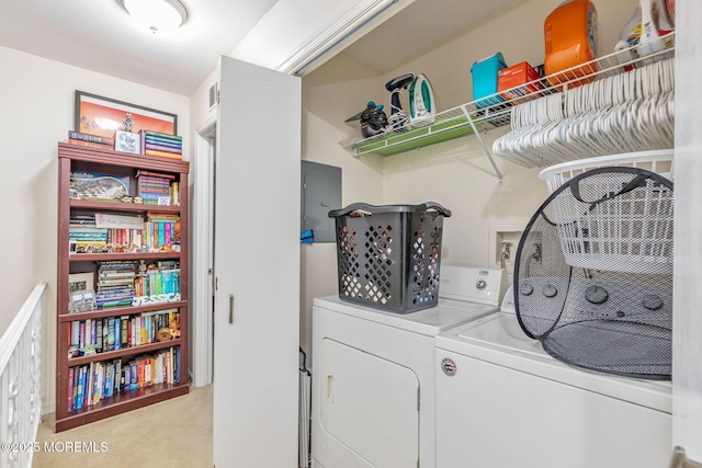 washroom featuring laundry area, washer and dryer, and light carpet