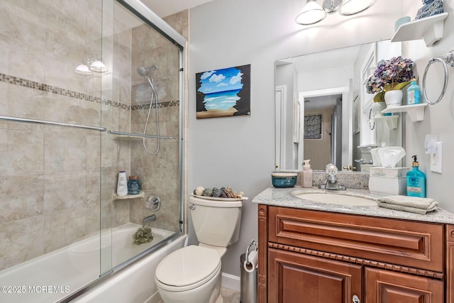 full bath with vanity, enclosed tub / shower combo, and toilet
