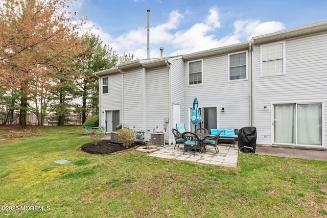 back of house featuring a patio, an outdoor living space, central air condition unit, and a yard