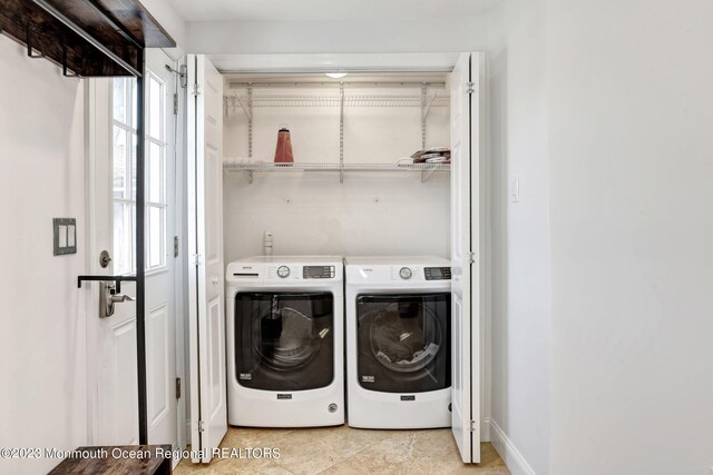 laundry area featuring independent washer and dryer, light tile patterned flooring, and laundry area
