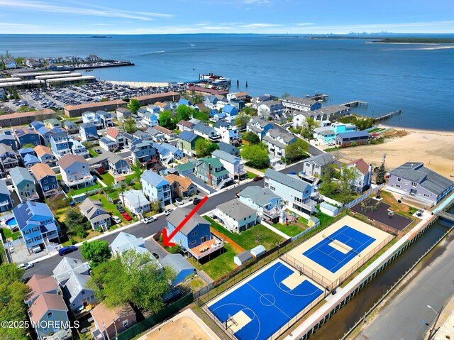 birds eye view of property featuring a water view and a residential view