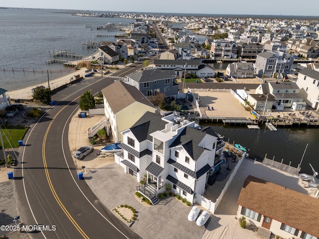 drone / aerial view with a residential view and a water view