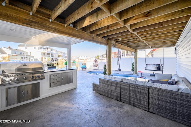 view of patio with area for grilling, fence, a fenced in pool, an outdoor kitchen, and outdoor lounge area