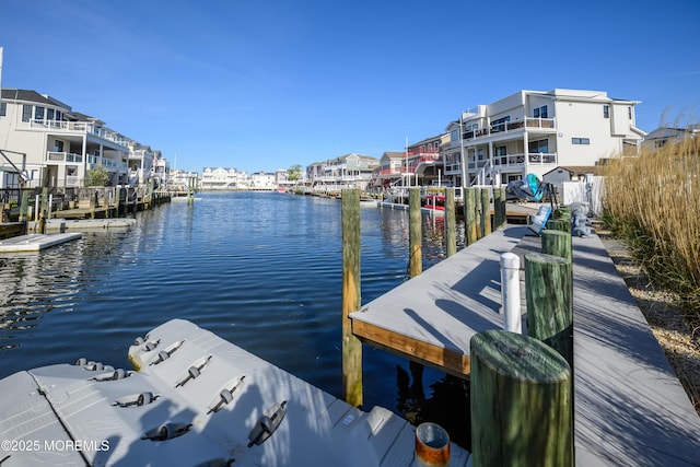 dock area featuring a residential view and a water view