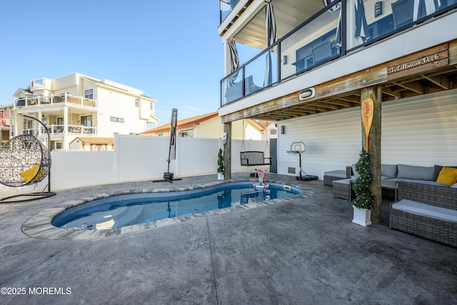 view of pool featuring a fenced in pool, outdoor lounge area, a patio area, and fence