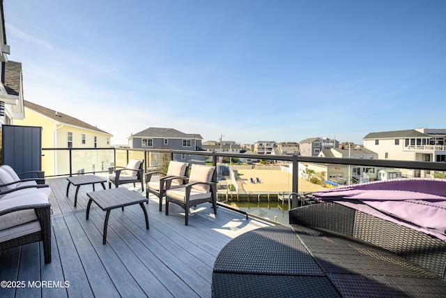 wooden deck with a residential view and an outdoor hangout area