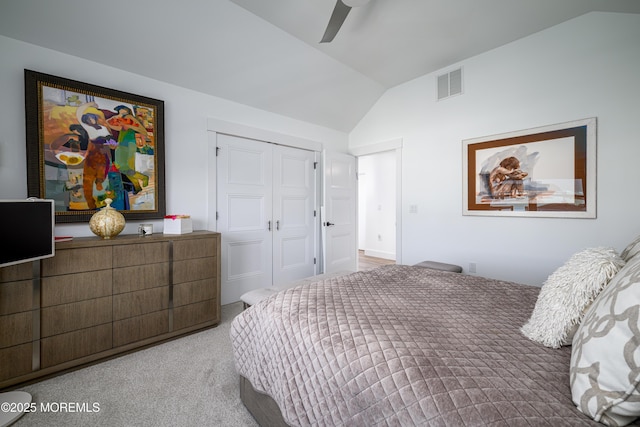 bedroom featuring ceiling fan, visible vents, carpet floors, a closet, and lofted ceiling