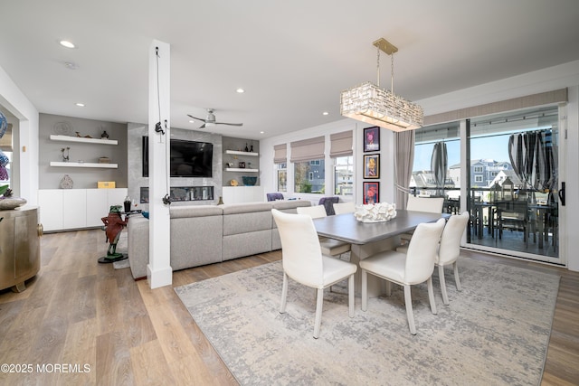 dining space with recessed lighting, ceiling fan, built in shelves, and light wood-type flooring