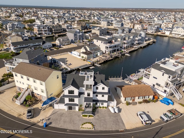 drone / aerial view featuring a water view and a residential view