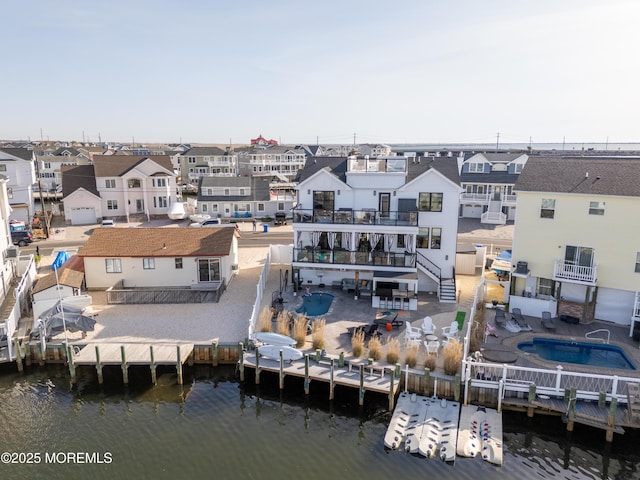 drone / aerial view with a residential view and a water view