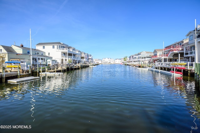 view of dock with a water view and a residential view