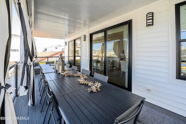 deck featuring covered porch and outdoor dining space