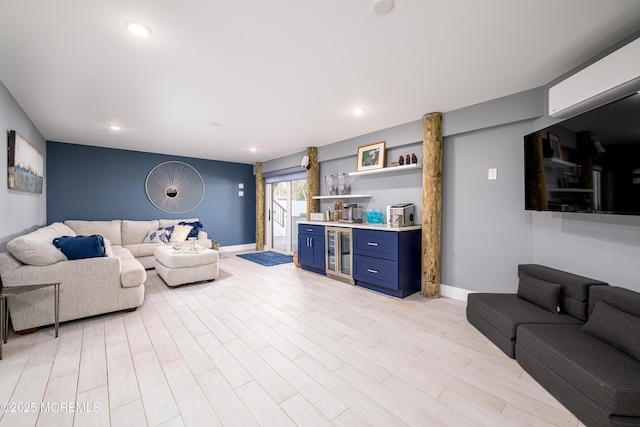 living room with bar, beverage cooler, recessed lighting, baseboards, and light wood-type flooring