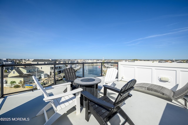view of patio / terrace featuring a fire pit and a balcony