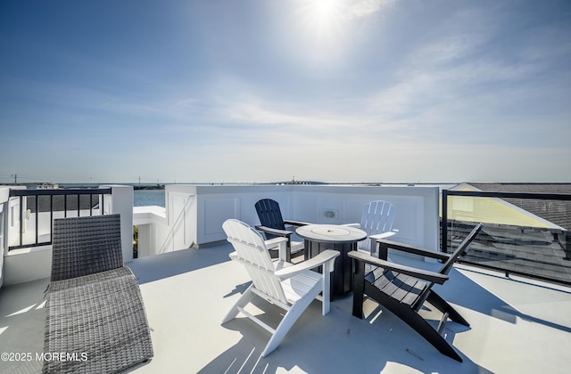 view of patio with outdoor dining area and a balcony