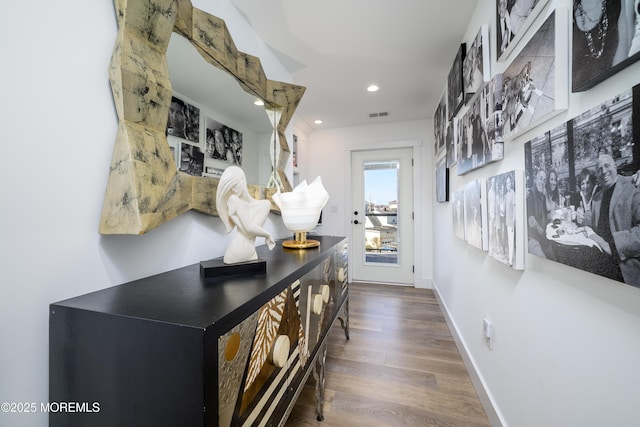 corridor with recessed lighting, baseboards, visible vents, and wood finished floors