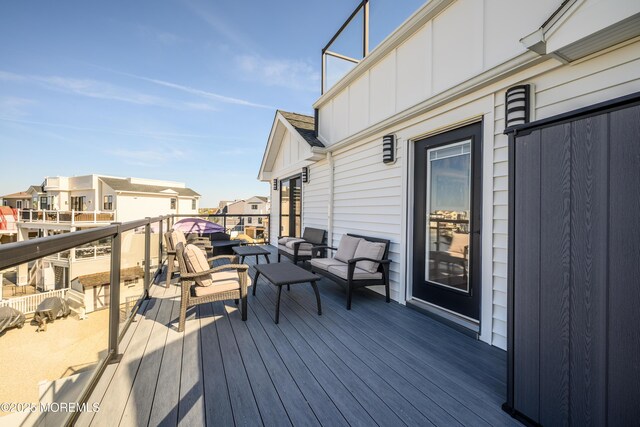 deck with outdoor lounge area and a residential view