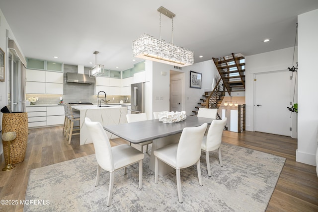 dining room with recessed lighting, stairs, wood finished floors, and visible vents