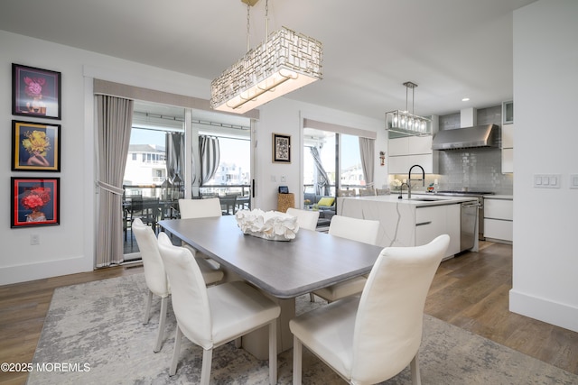 dining space with baseboards and wood finished floors