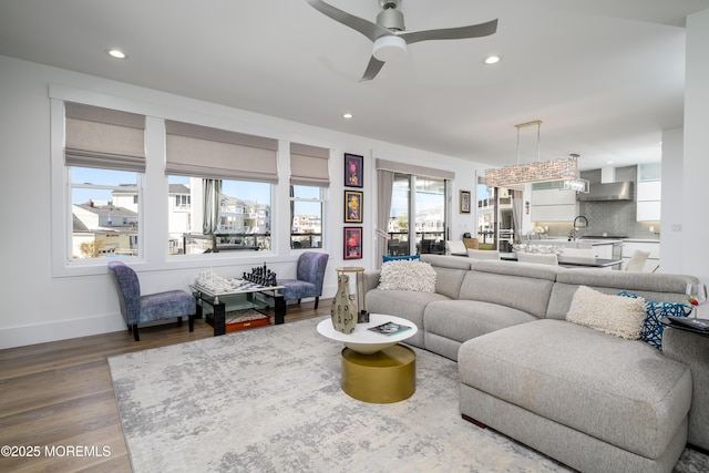 living room with recessed lighting, baseboards, ceiling fan, and wood finished floors