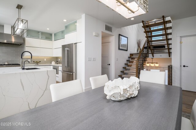 dining room with stairs, recessed lighting, visible vents, and wood finished floors