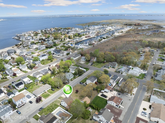 drone / aerial view with a residential view and a water view