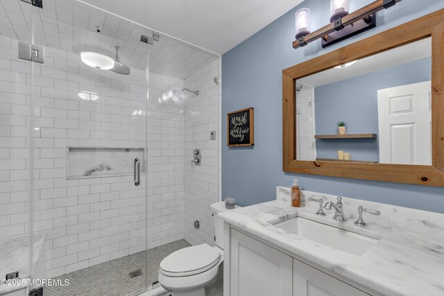 bathroom with vanity, toilet, and a stall shower