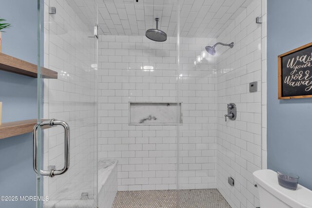 full bath with toilet and a stall shower