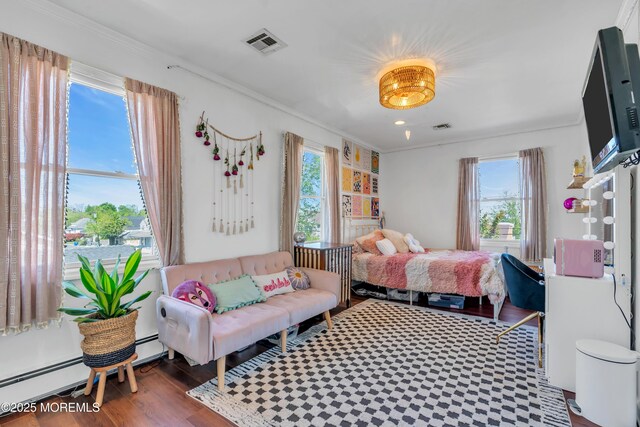 bedroom featuring visible vents, crown molding, and baseboard heating