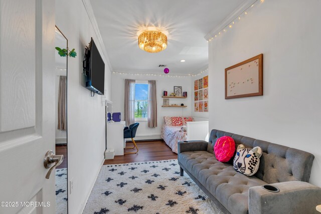 living area with baseboards, ornamental molding, wood finished floors, and a baseboard radiator